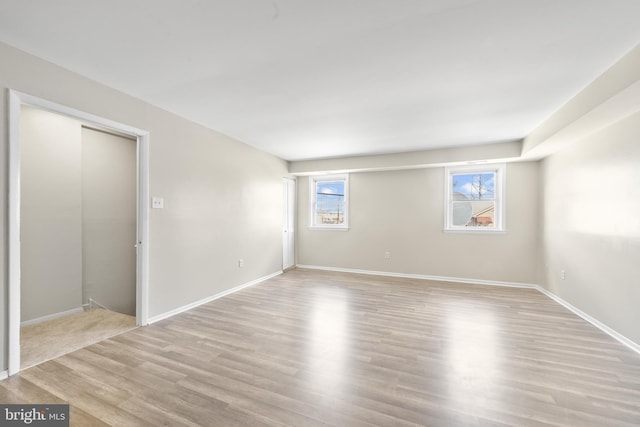 unfurnished room with baseboards and wood finished floors