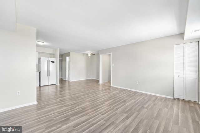 interior space featuring baseboards and light wood-type flooring