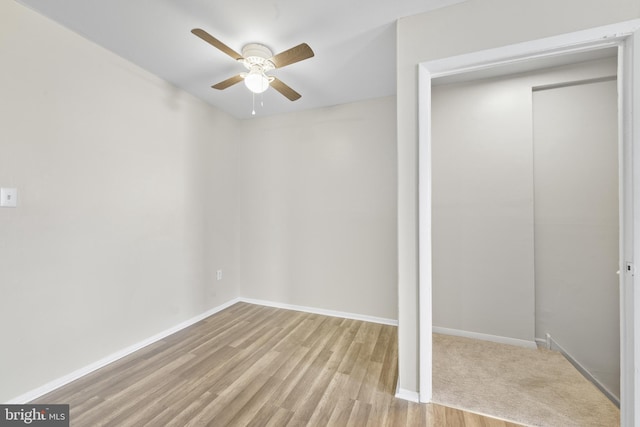 unfurnished bedroom with ceiling fan, baseboards, and wood finished floors