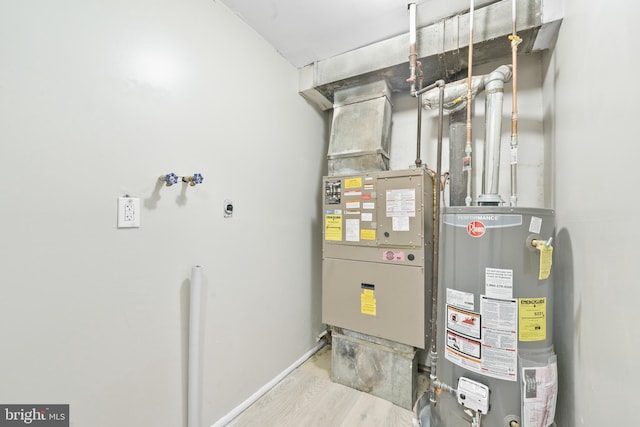 utility room with heating unit and water heater