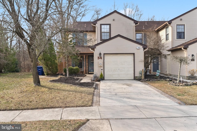 traditional-style home with a garage, concrete driveway, and a front yard