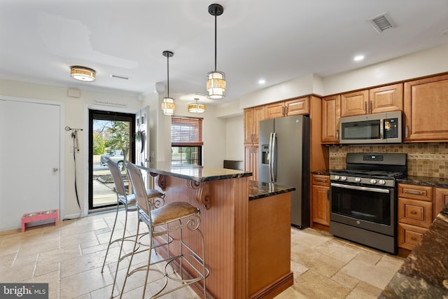 kitchen featuring dark stone countertops, stone tile floors, visible vents, decorative backsplash, and appliances with stainless steel finishes