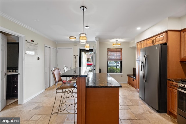 kitchen with stainless steel refrigerator with ice dispenser, dark stone countertops, a kitchen breakfast bar, stone tile floors, and baseboards