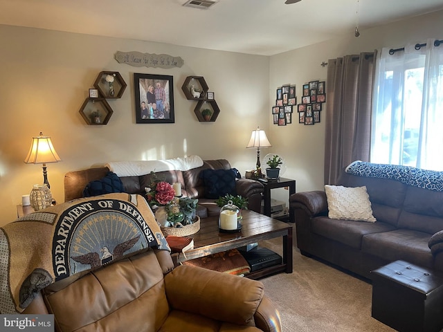 living room featuring visible vents and carpet