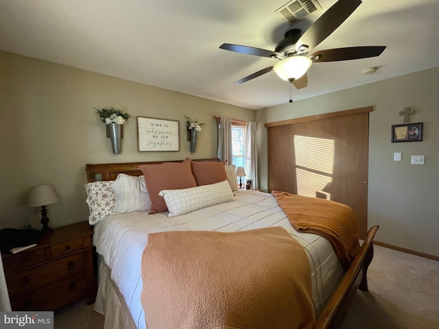 bedroom with visible vents, baseboards, carpet, and a ceiling fan