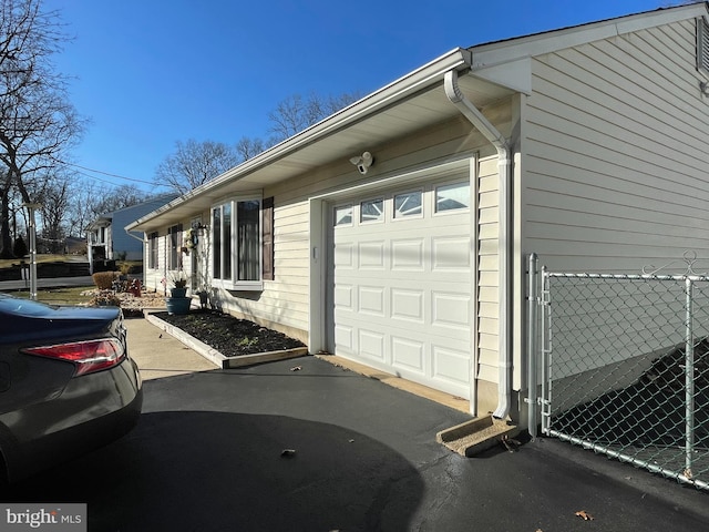 view of side of property with a garage and driveway