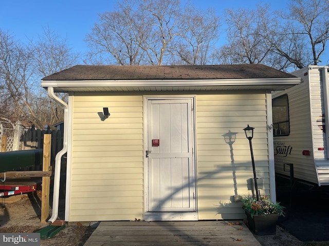 view of shed featuring fence