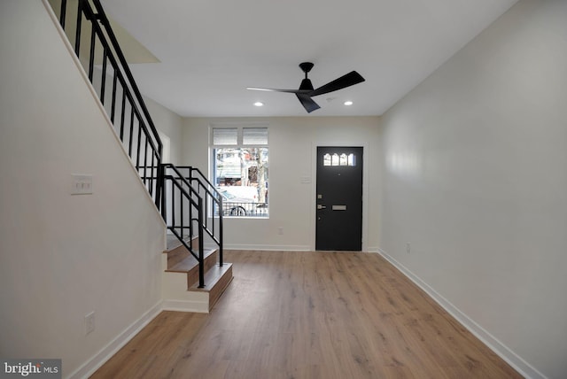 foyer with wood finished floors, baseboards, recessed lighting, ceiling fan, and stairs