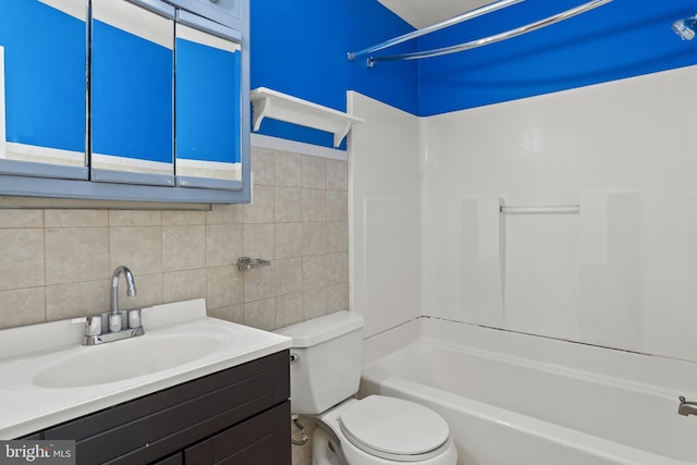 bathroom featuring tile walls, toilet, vanity, and  shower combination