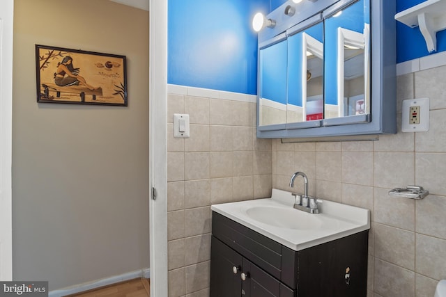 bathroom with tile walls and vanity