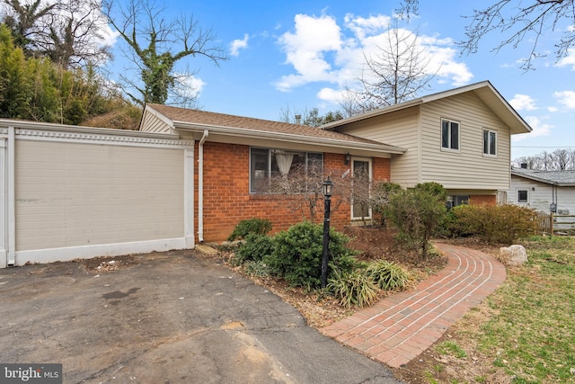 tri-level home with brick siding