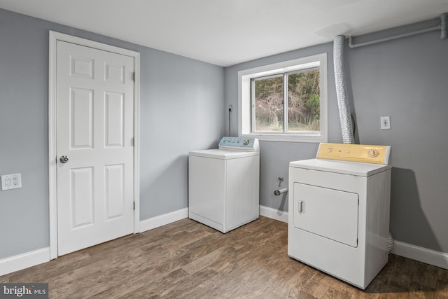 washroom with laundry area, wood finished floors, baseboards, and washing machine and clothes dryer