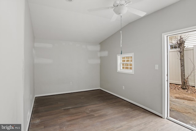 spare room featuring ceiling fan, a wealth of natural light, lofted ceiling, and wood finished floors