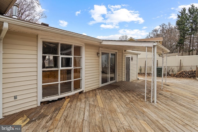 wooden terrace featuring fence