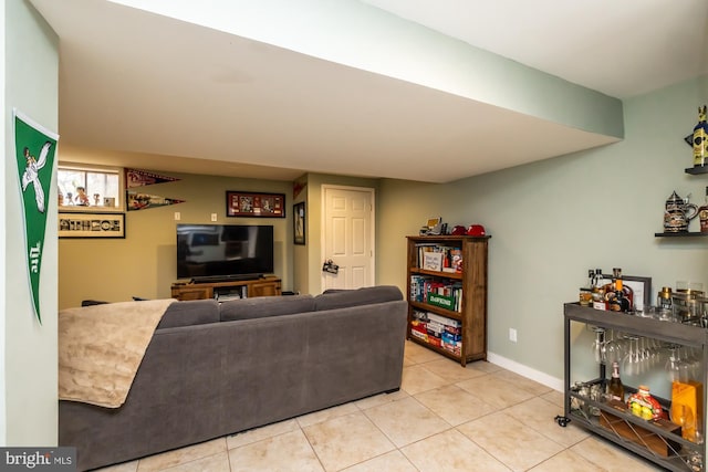 living area featuring baseboards and light tile patterned flooring