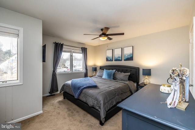 bedroom with baseboards, light colored carpet, and a ceiling fan