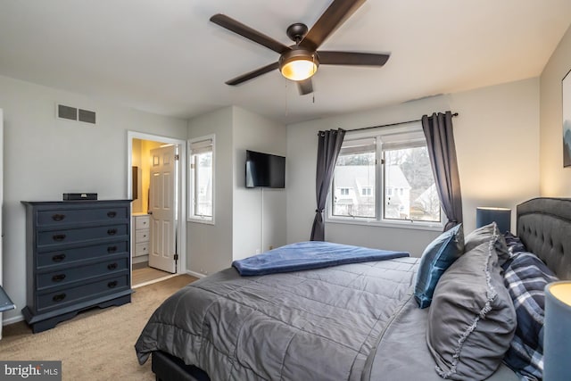 bedroom with visible vents, light carpet, baseboards, and ceiling fan