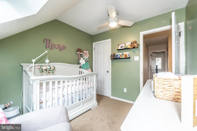 bedroom with baseboards, carpet, lofted ceiling, a ceiling fan, and a nursery area