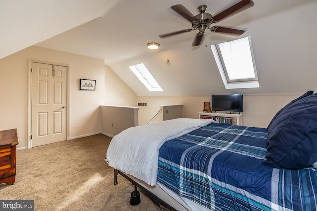 bedroom with visible vents, lofted ceiling with skylight, a ceiling fan, carpet, and baseboards