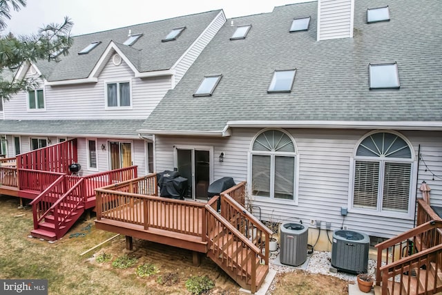 rear view of house with a wooden deck, central AC, stairway, and a shingled roof