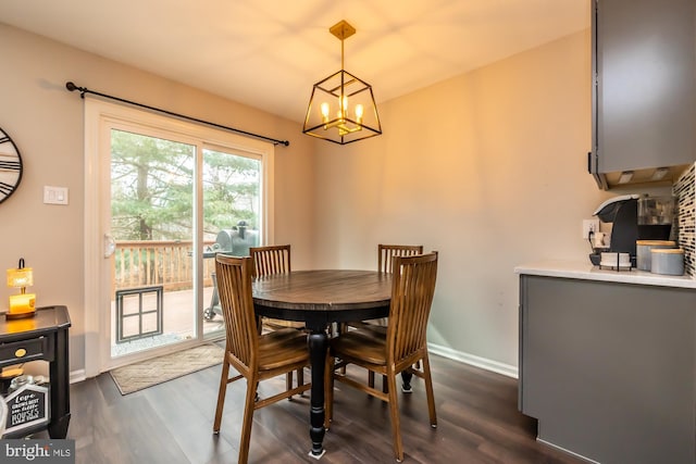 dining room with baseboards, a notable chandelier, and dark wood finished floors