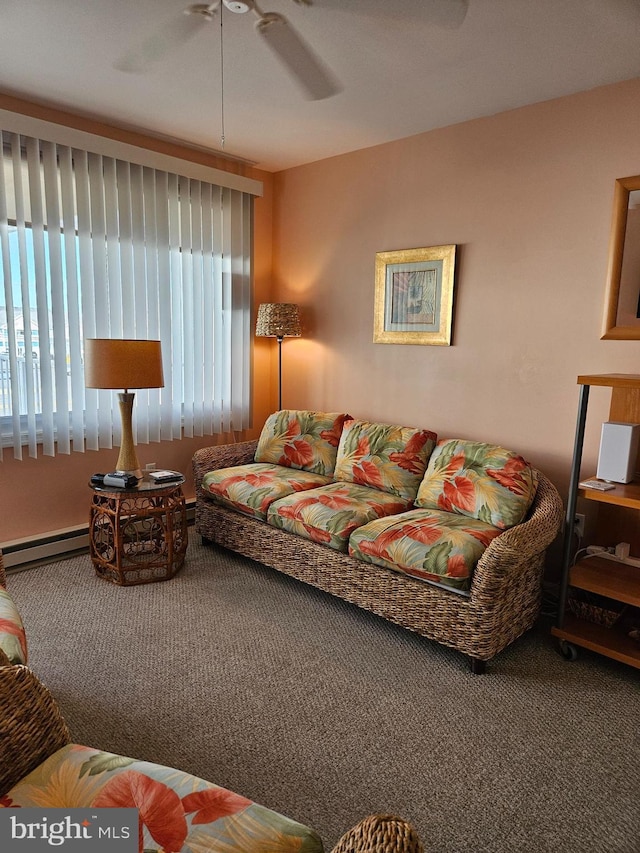 living area featuring carpet flooring, baseboard heating, and ceiling fan