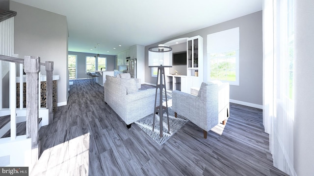 living room with dark wood-type flooring and baseboards