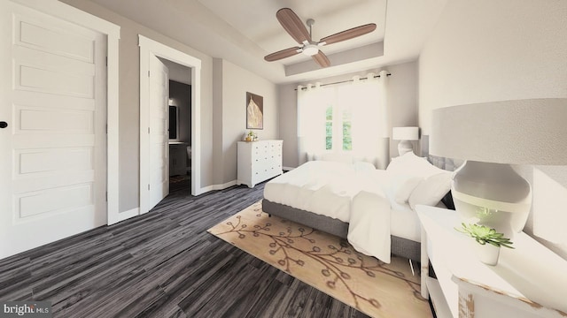 bedroom with a ceiling fan, a tray ceiling, baseboards, and dark wood-style flooring