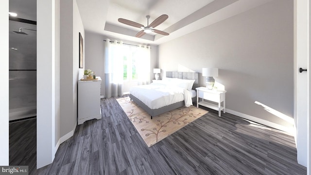 bedroom with a ceiling fan, a raised ceiling, baseboards, and wood finished floors