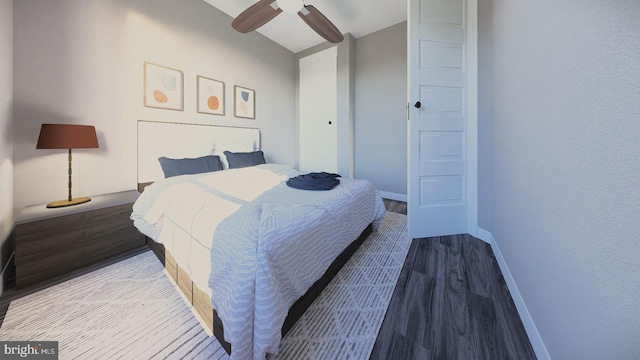 bedroom with a ceiling fan, lofted ceiling, baseboards, and wood finished floors