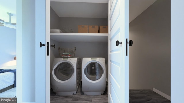 laundry room with washing machine and clothes dryer, laundry area, and wood finished floors