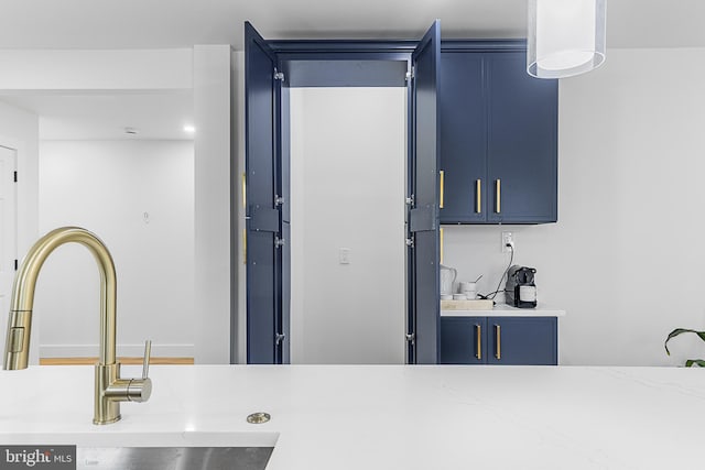 kitchen featuring blue cabinetry and a sink