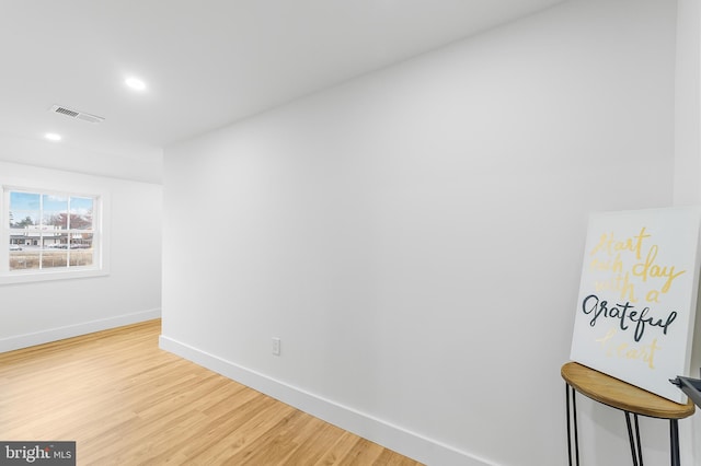 empty room with recessed lighting, light wood-style floors, visible vents, and baseboards