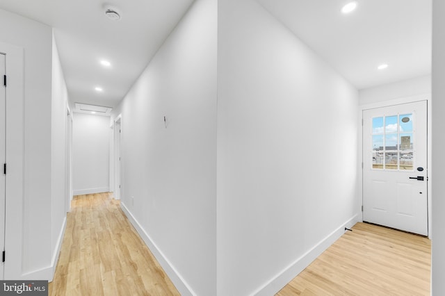 hallway featuring light wood finished floors, recessed lighting, attic access, and baseboards