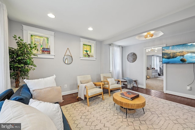 living area with recessed lighting, baseboards, and wood finished floors