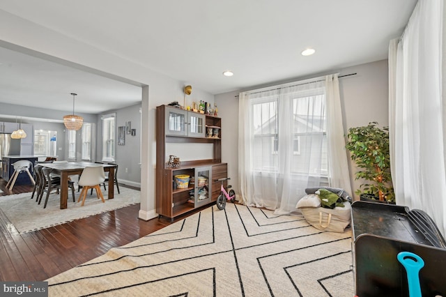 living area with recessed lighting, baseboards, and dark wood-style floors