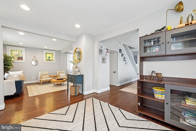 interior space with a wealth of natural light, stairway, and hardwood / wood-style flooring