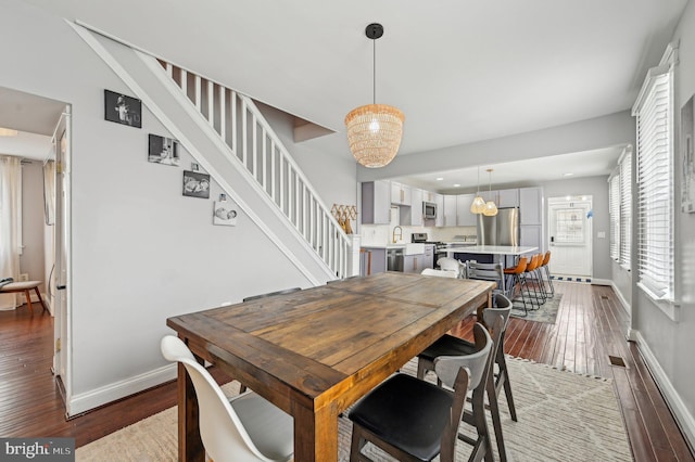 dining room with visible vents, stairs, baseboards, and dark wood-style flooring