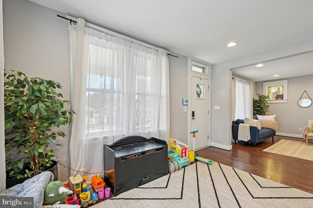 game room with recessed lighting, wood finished floors, and baseboards