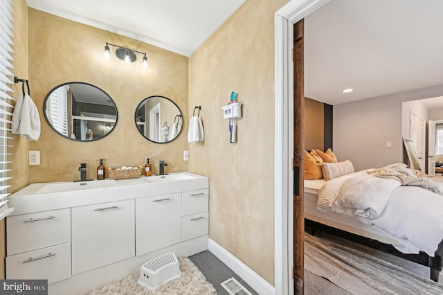 full bathroom with double vanity, visible vents, ensuite bathroom, and a sink