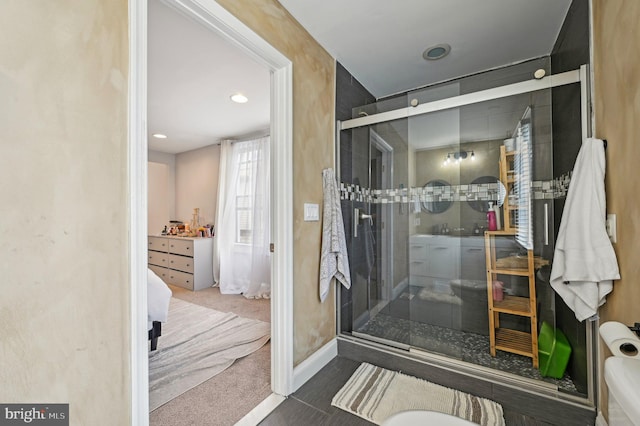 full bathroom featuring a shower stall and baseboards