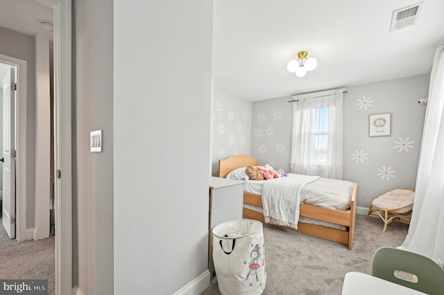 bedroom with wallpapered walls, baseboards, visible vents, and carpet floors