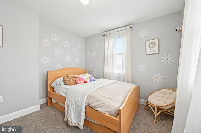 carpeted bedroom featuring wallpapered walls and baseboards