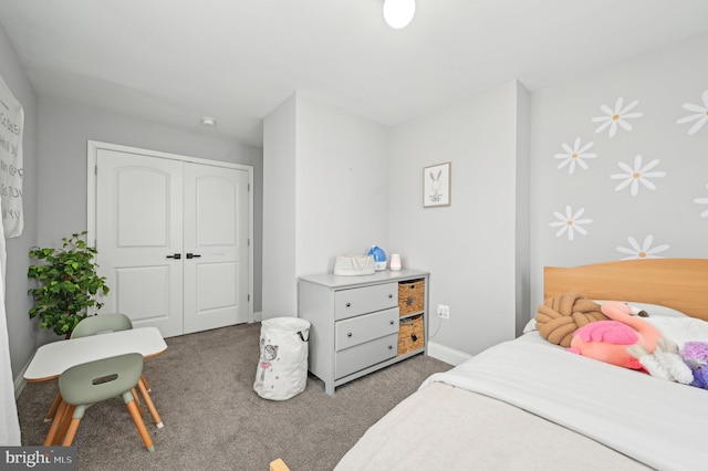 carpeted bedroom featuring a closet and baseboards