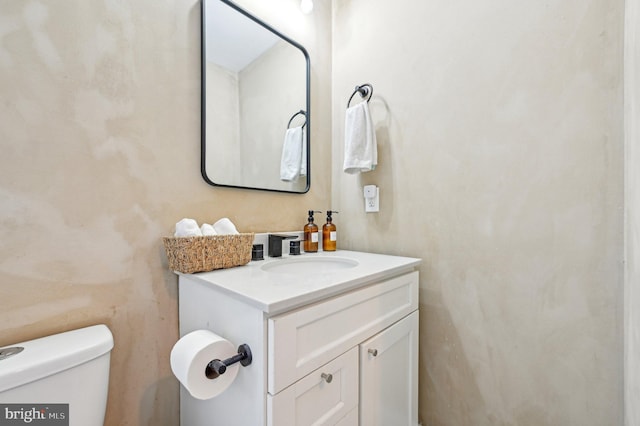 half bath featuring toilet and vanity