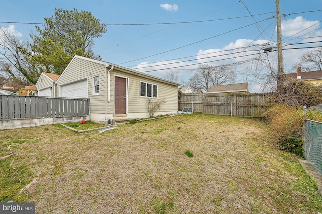 exterior space featuring a fenced backyard, entry steps, an outbuilding, and a yard