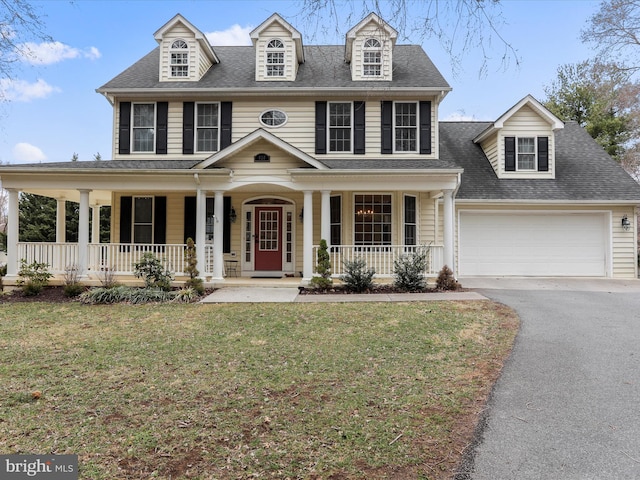 view of front facade with a front yard, driveway, a porch, a shingled roof, and a garage