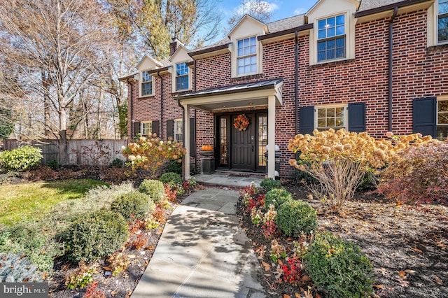 exterior space featuring fence and brick siding