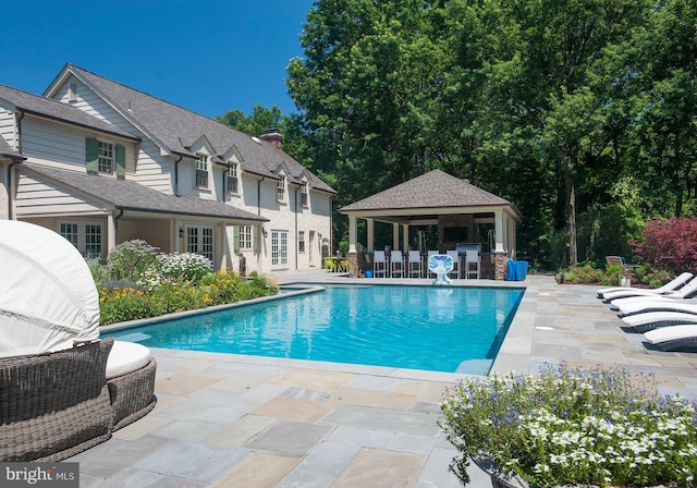 outdoor pool with a patio area