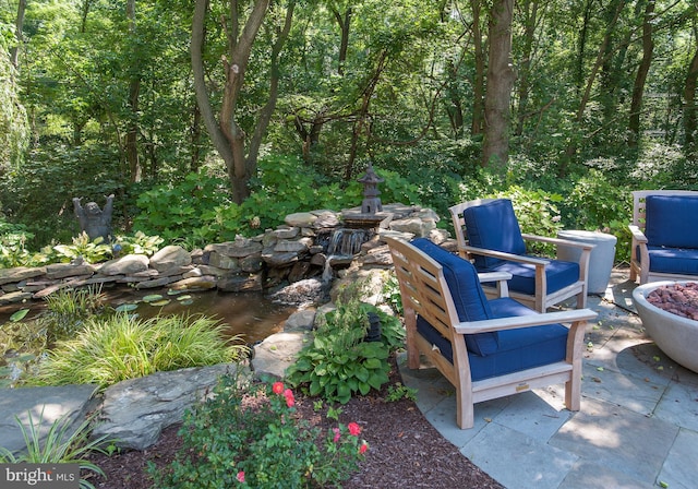 view of patio / terrace with a forest view